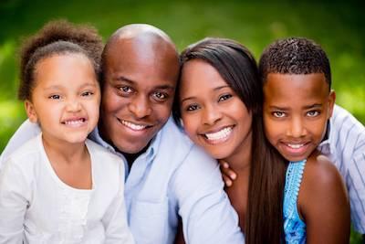 family of four smiling l white bear smiles