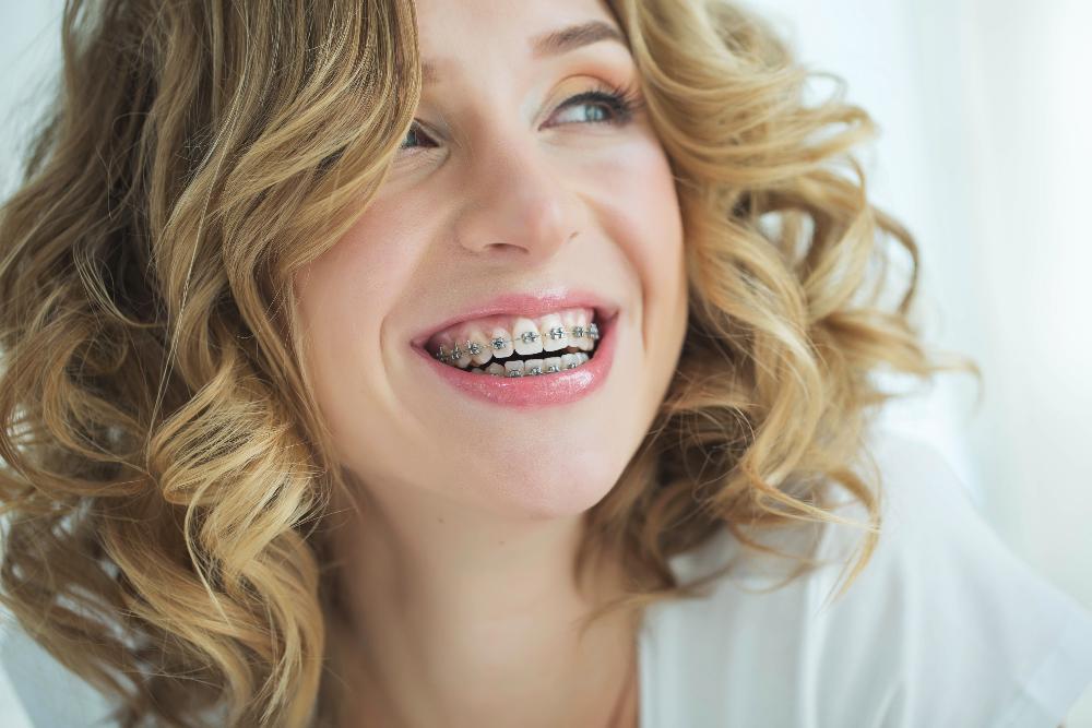 woman with braces & curly hair l dentist near me