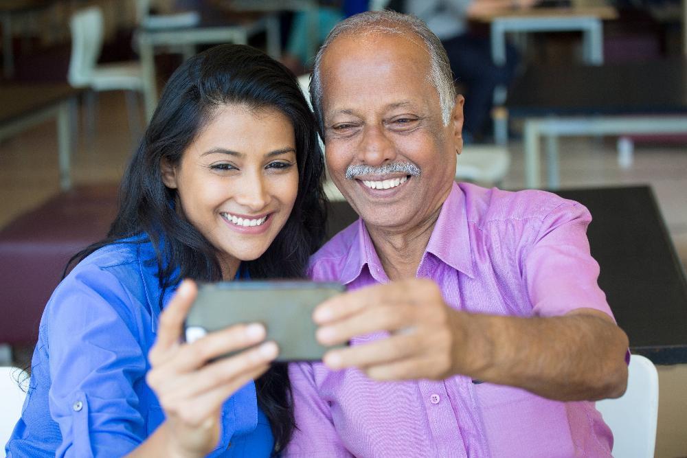 man with young woman taking a selfie l dentist near me