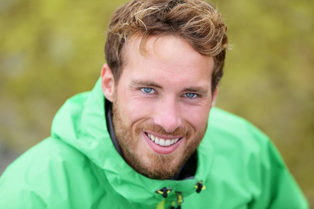 man in green jacket smiling | dental fillings white bear lake