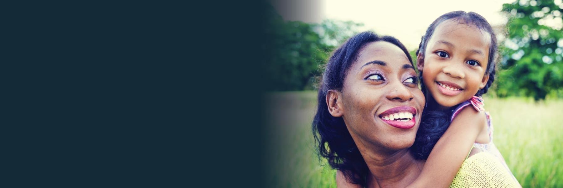 Mother with daughter on shoulders | Dentist in white bear lake mn