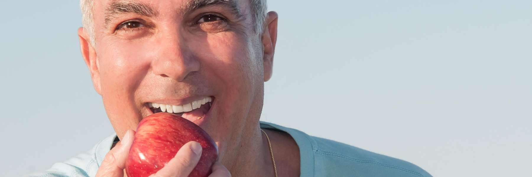 man eating apple | white bear dentist