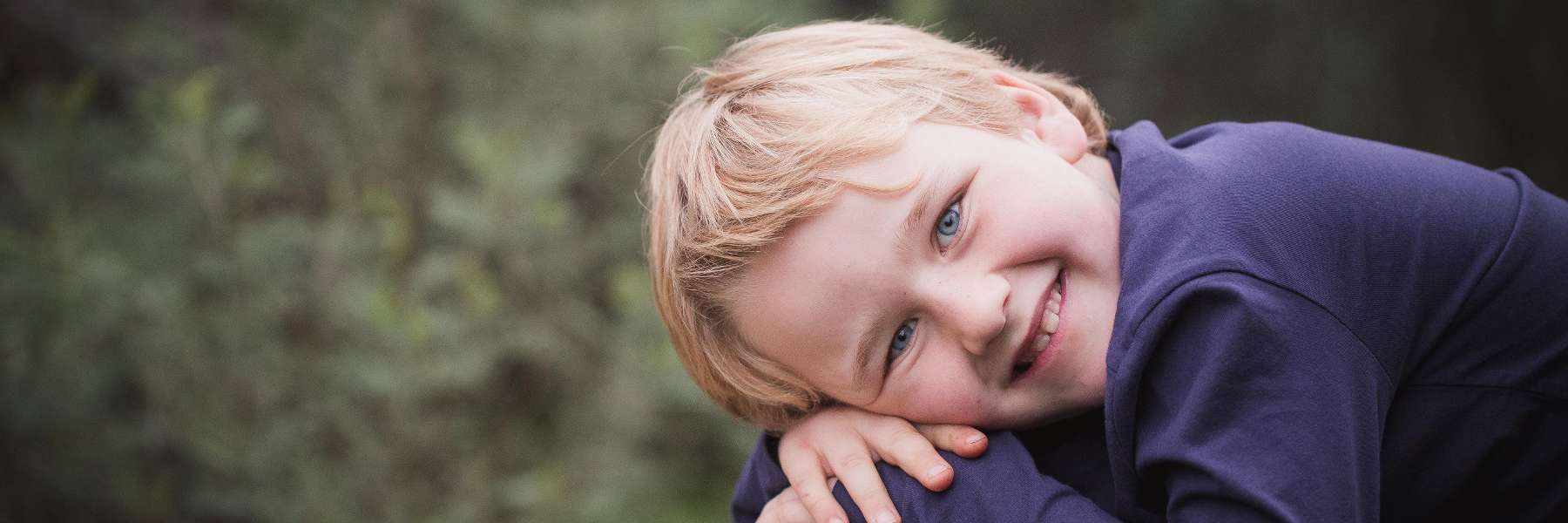 blonde kid with blue eyes smiling