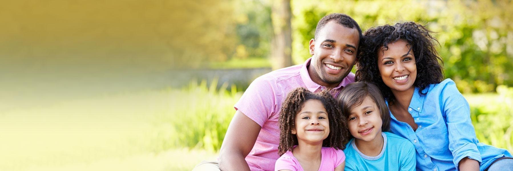 family of four smiling outside l dentist white bear lake