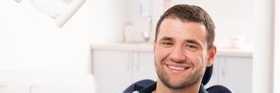 man smiling in dental office l gentle dentistry white bear lake