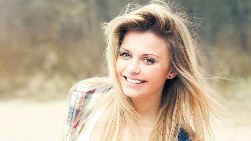 Smiling patient happy with White Bear Lake CEREC crown