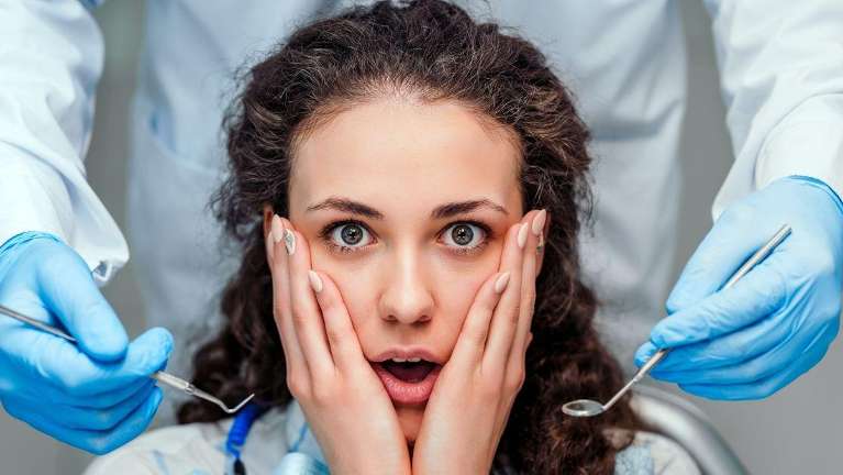 woman holding her cheeks