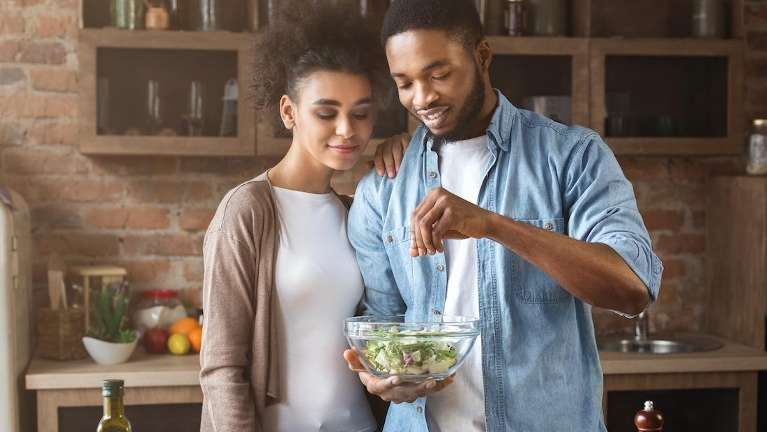 couple making a salad