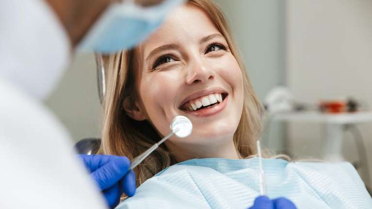 woman smiling in dentist exam chair | cosmetic dentistry white bear lake mn