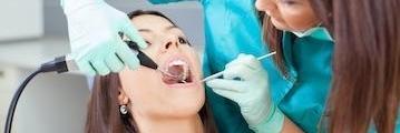 woman receiving dental exam l family dentist near me