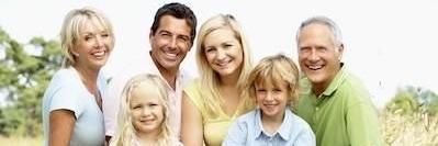 family of six smiling outside l family dentist near me