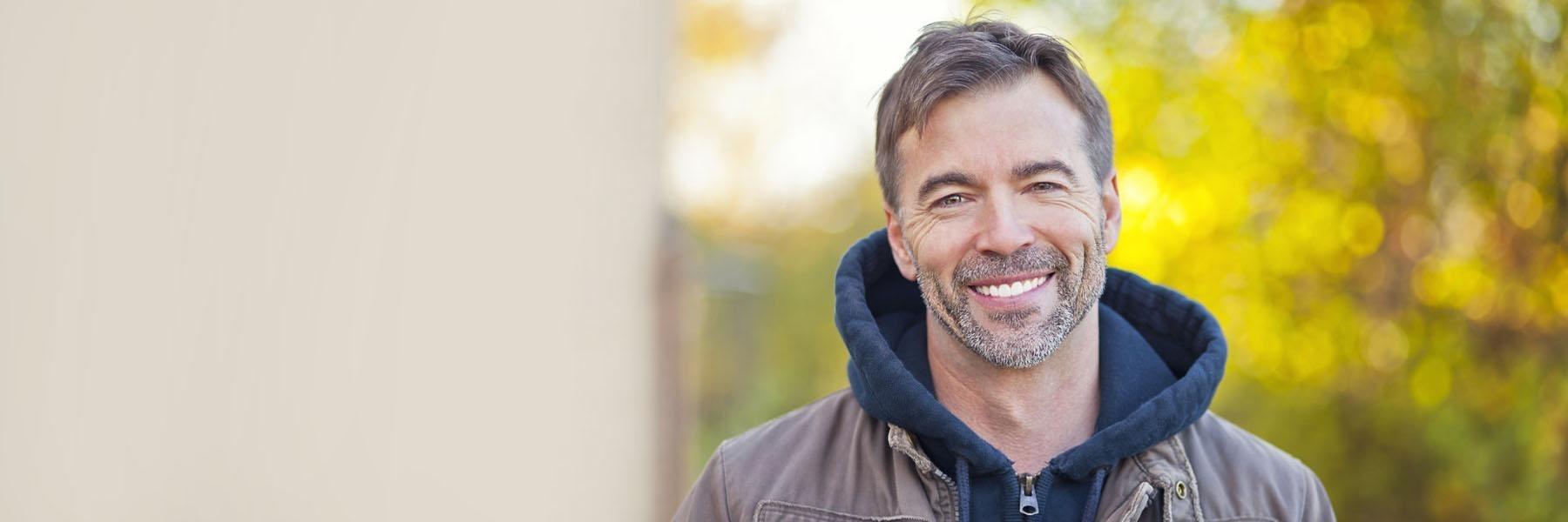 Man with facial hair smiling l Dentist White Bear Lake MN