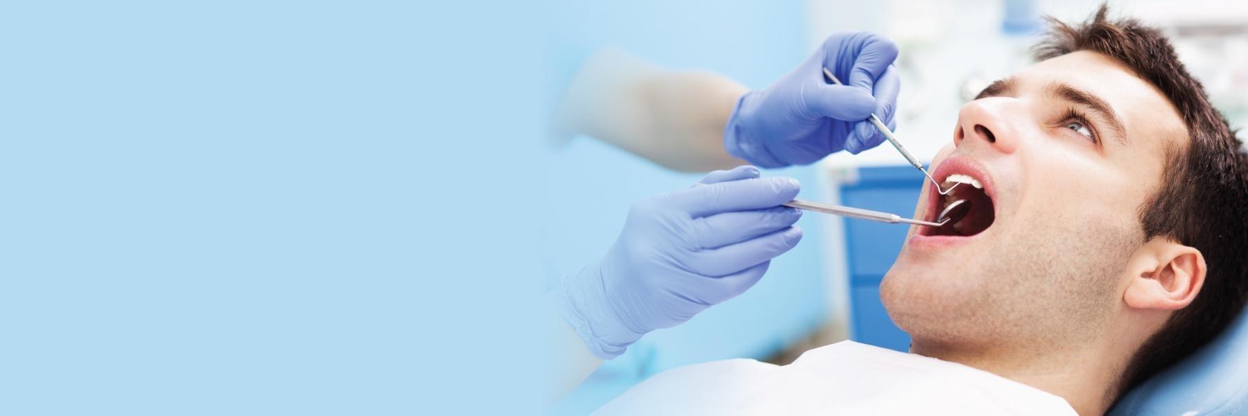 Man receiving dental exam l Emergency Dentist White Bear Lake, MN